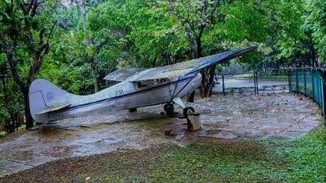 Pushpak aircraft near the department of Aerospace engineering on a rainy day.